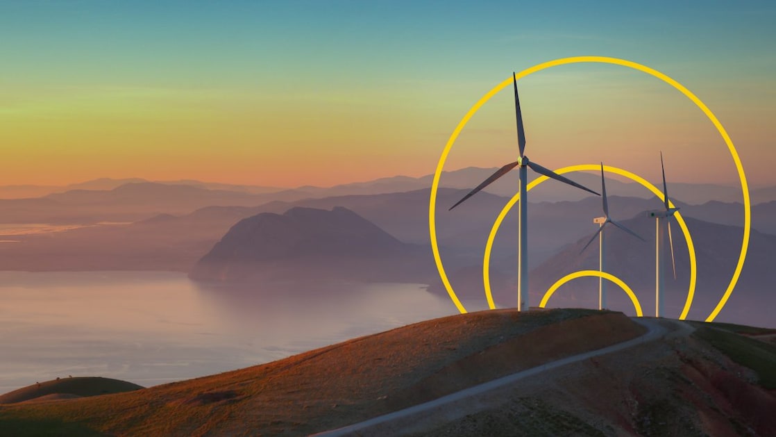 Photo of three wind turbines on a hill with an outline of the Achieving net-zero emissions graph